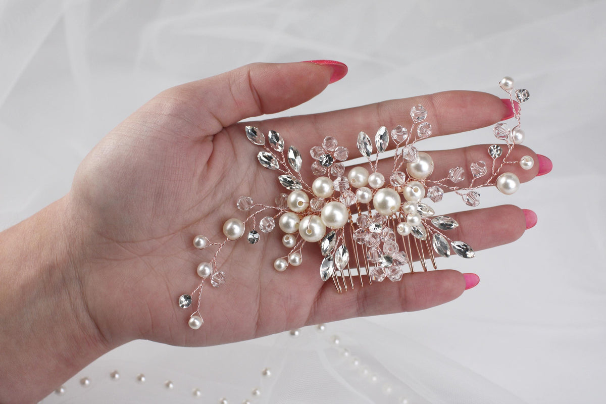 a woman's hand holding a bunch of pearls