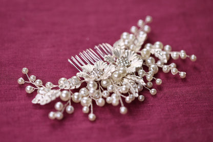 a close up of a hair comb with pearls