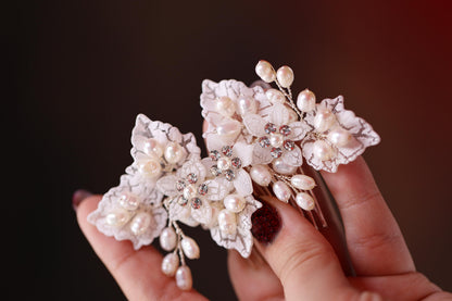 a hand holding a hair comb with flowers on it