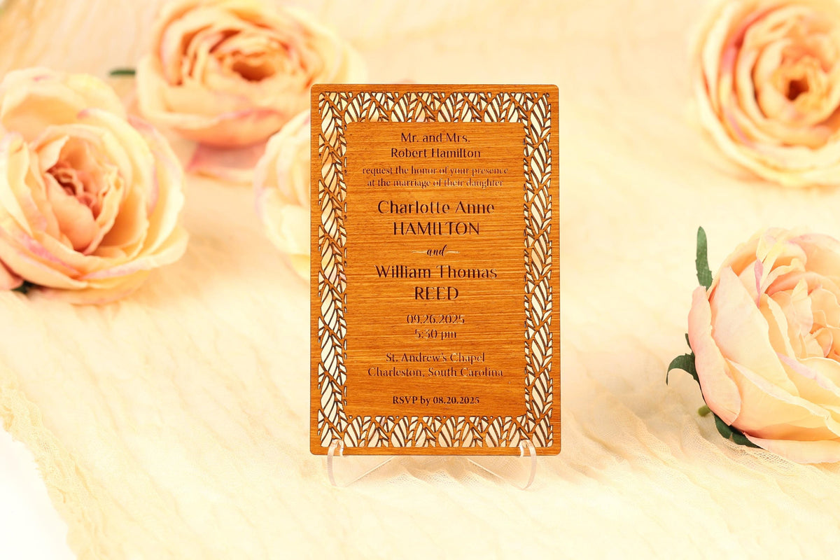 A wooden wedding invitation card with text and decorative elements, surrounded by peach-colored roses.