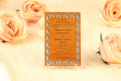A wooden wedding invitation card with text and decorative elements, surrounded by peach-colored roses.
