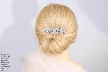 A close-up of a woman's blonde hair with a decorative hair accessory, such as a flower or crystal piece, in the back of her head.