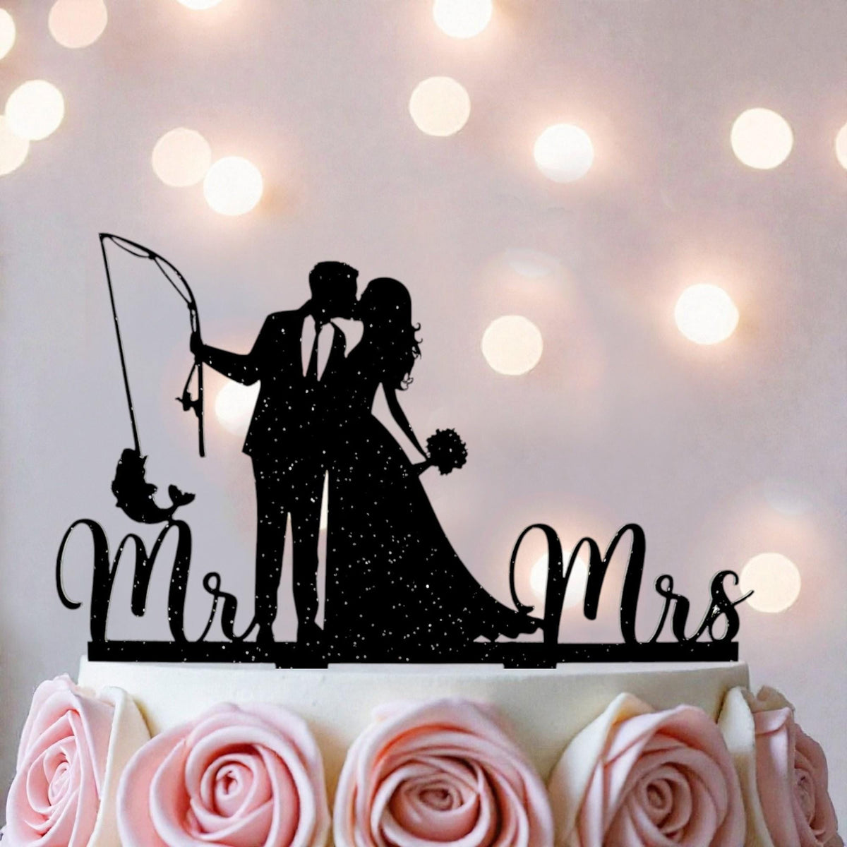 A silhouette of a couple embracing, with the words "Mr. and Mrs." written on a cake topper.