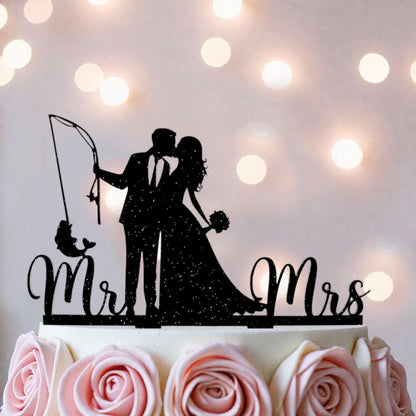 A silhouette of a couple embracing, with the words "Mr. and Mrs." written on a cake topper.