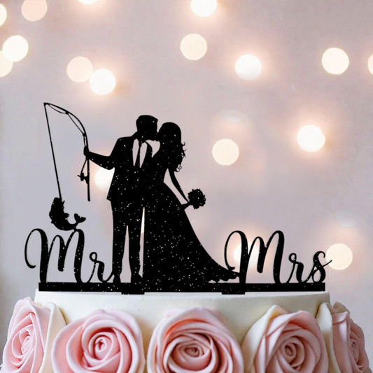 A silhouette of a couple embracing, with the words "Mr. and Mrs." written on a cake topper.