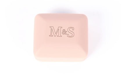 A pink square box with the letters 'M&S' printed on it.