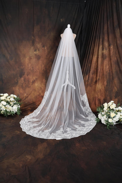 a bridal veil with flowers on a table