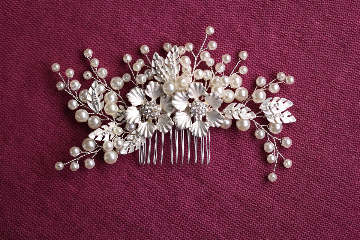 a hair comb decorated with pearls and leaves