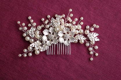 a hair comb decorated with pearls and leaves