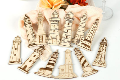 a collection of wooden lighthouse cutouts arranged on a white surface.