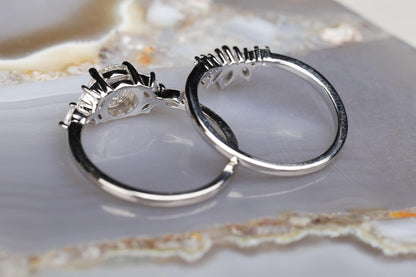 a couple of silver rings sitting on top of a white plate