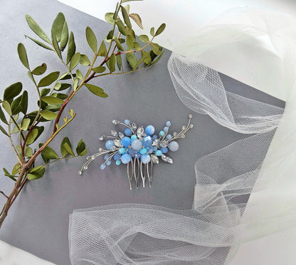 a bridal hair comb with blue flowers and leaves