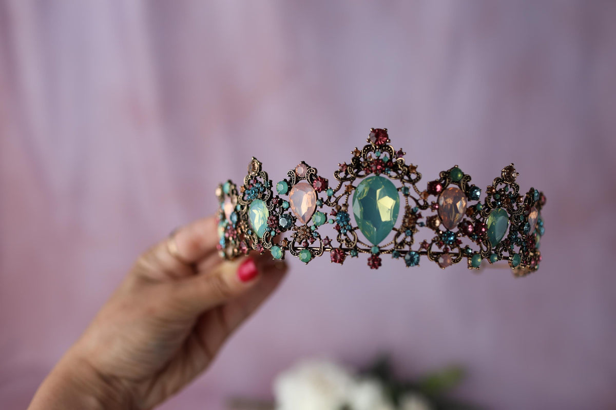 a woman holding a tiara in her hand