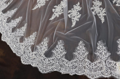a close up of a white lace on a dress