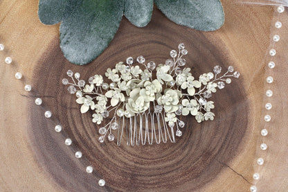 a hair comb with white flowers and leaves