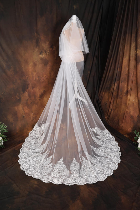 a wedding veil with a lace edge on a mannequin
