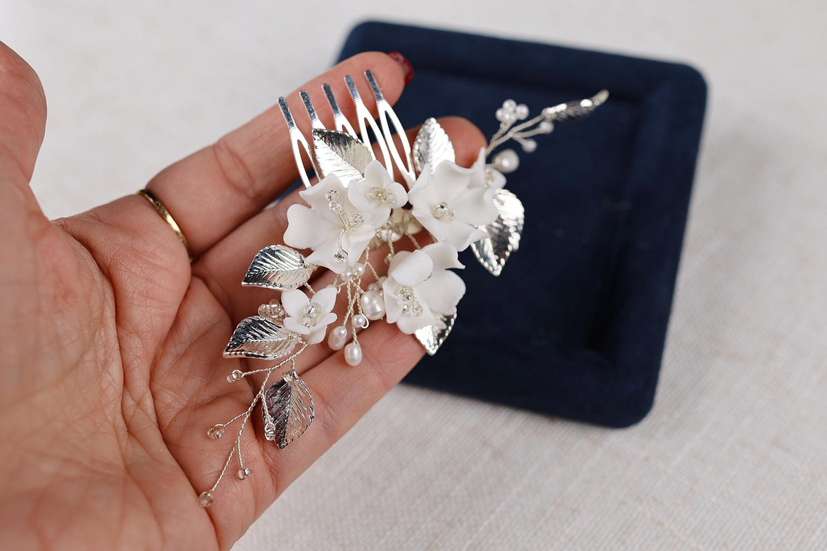 a person holding a fork with flowers on it