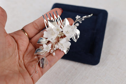 a person holding a fork with flowers on it