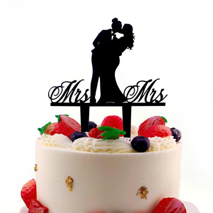 a wedding cake with a silhouette of a bride and groom