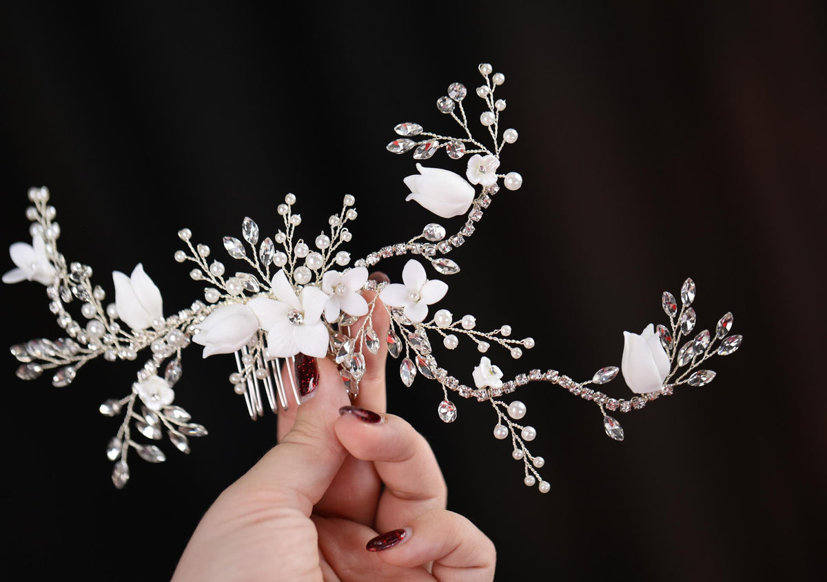 a woman is holding a bridal hair comb