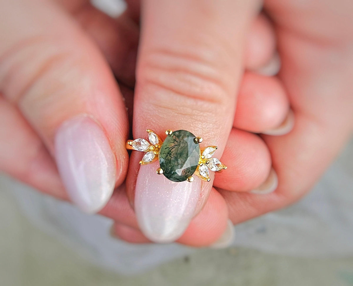 a close up of a person holding a ring