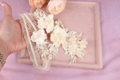 a woman's hand holding a piece of cloth with flowers on it
