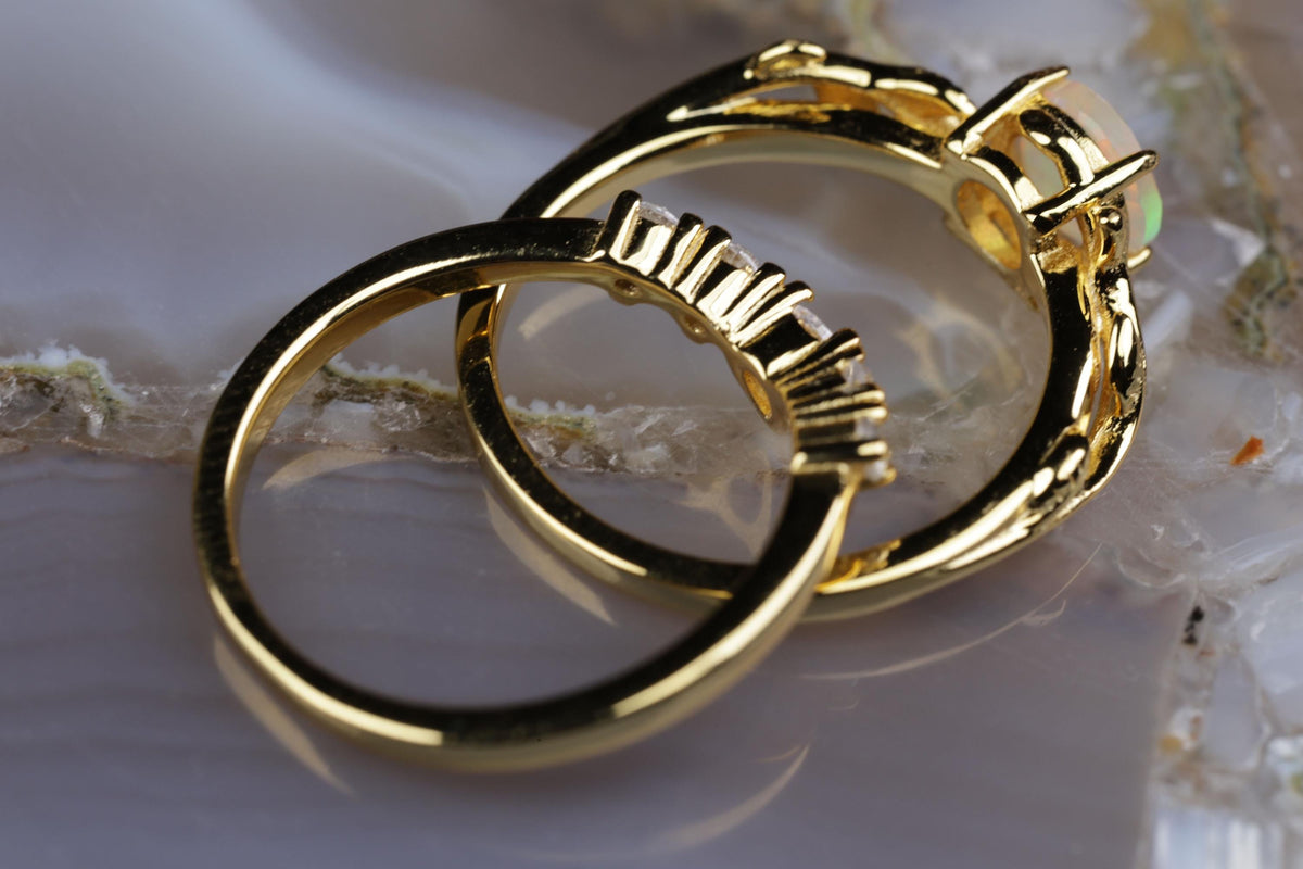 a couple of gold rings sitting on top of a table