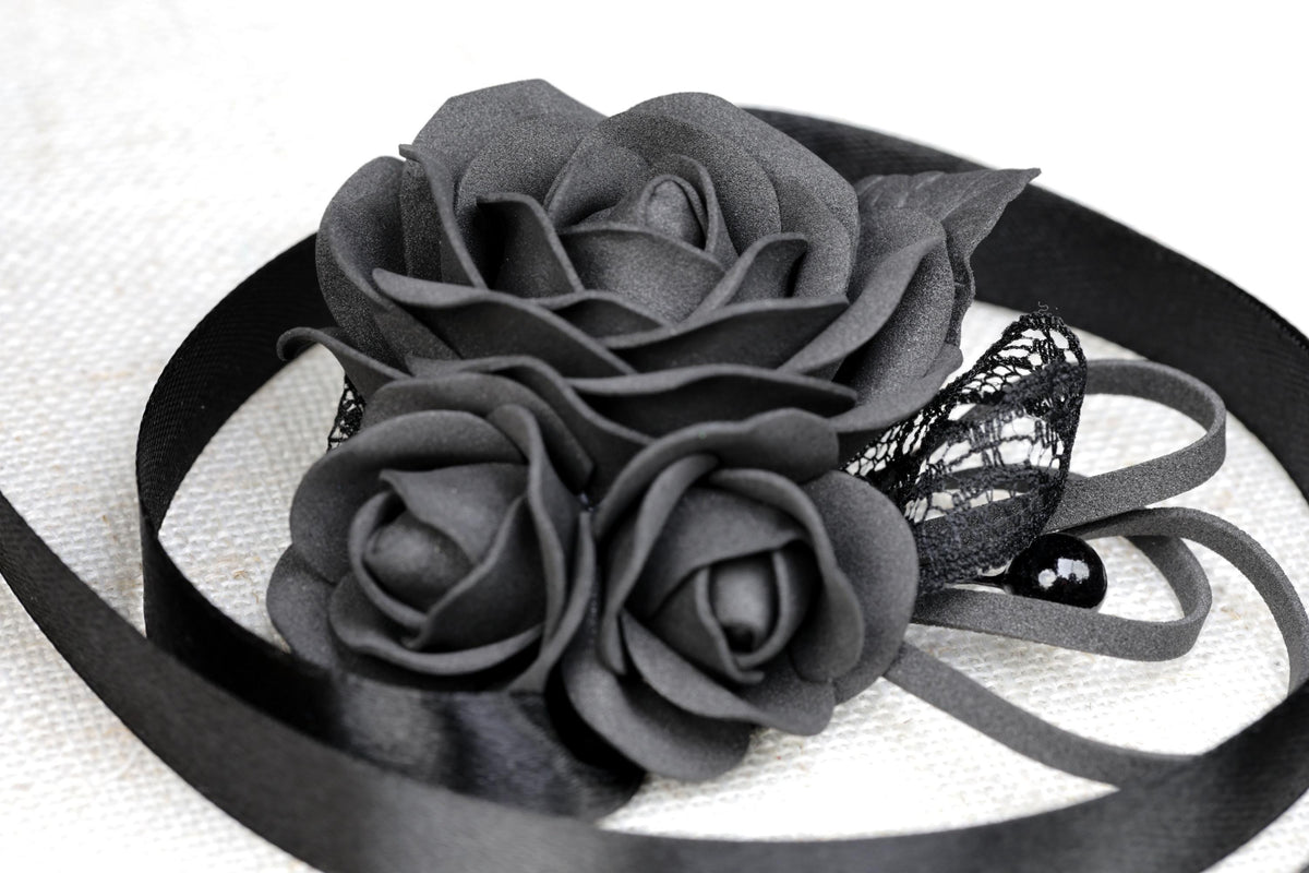 a close up of a flower on a ribbon