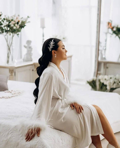 a woman in a white dress sitting on a bed