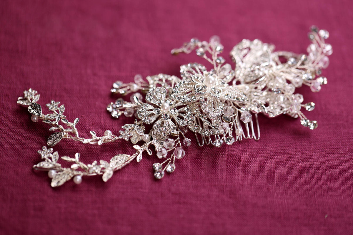 a close up of a hair comb on a pink surface