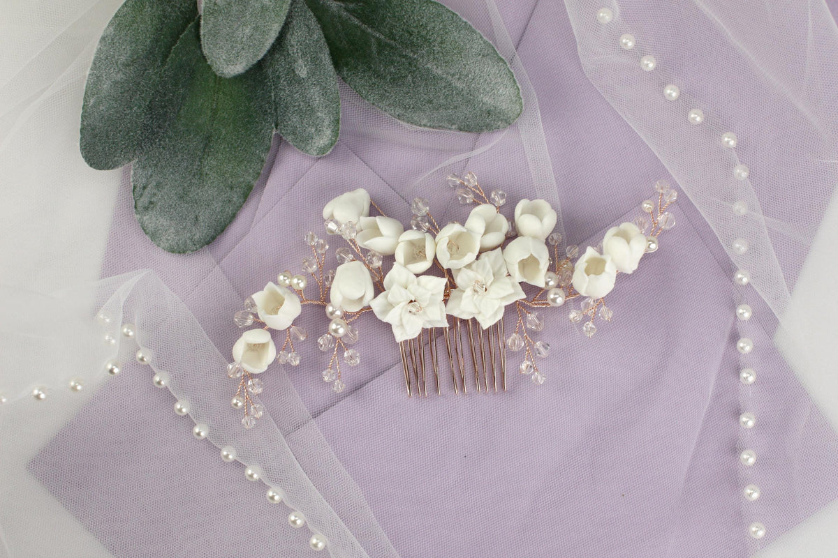 a bridal hair comb with white flowers and pearls