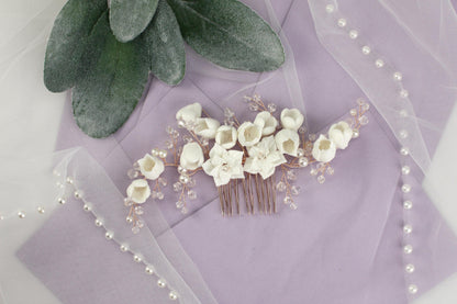 a bridal hair comb with white flowers and pearls