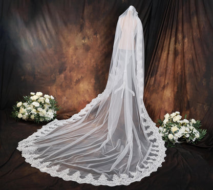 a bridal veil with a bouquet of white flowers