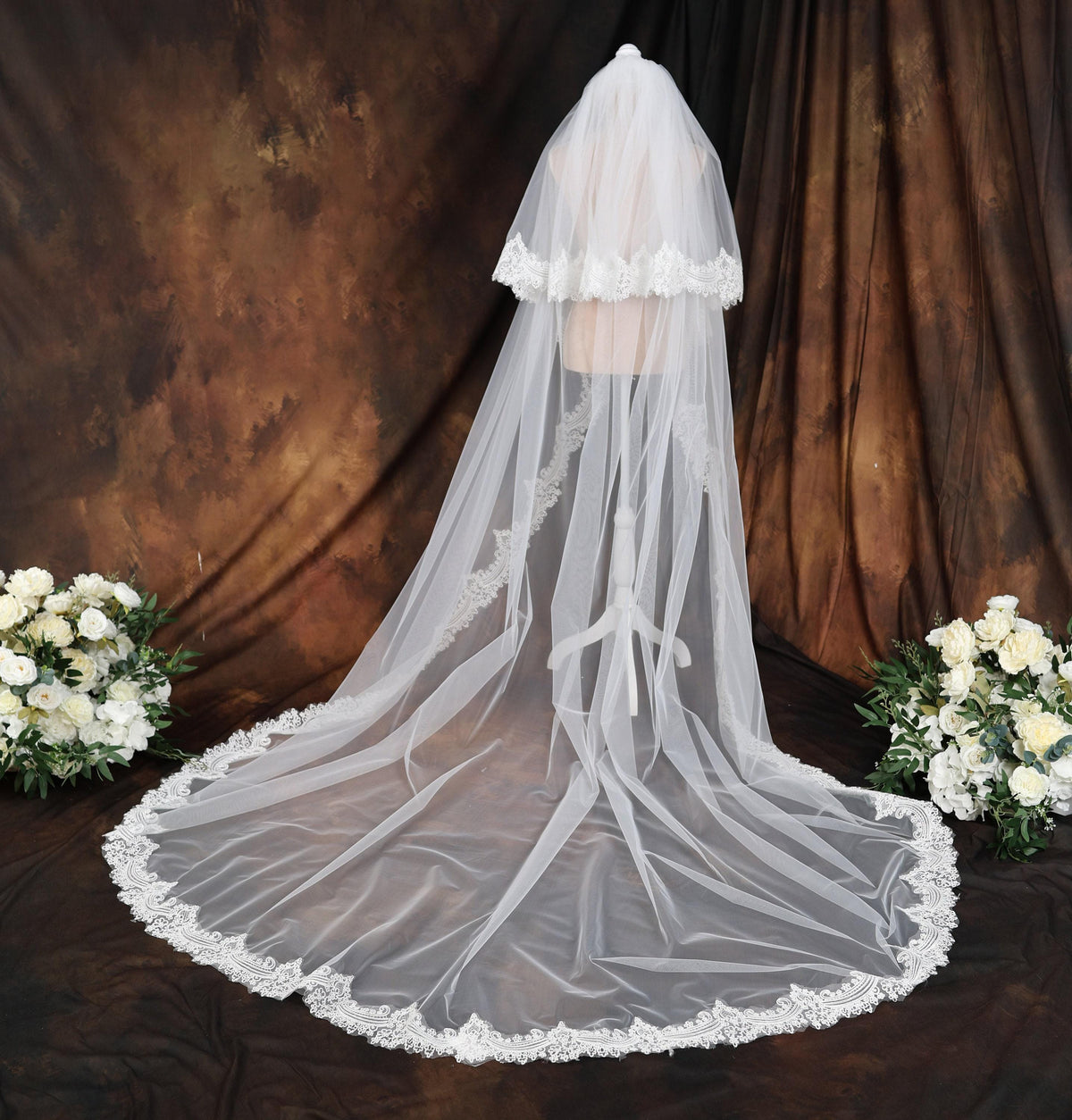 a bridal veil with white flowers on a table