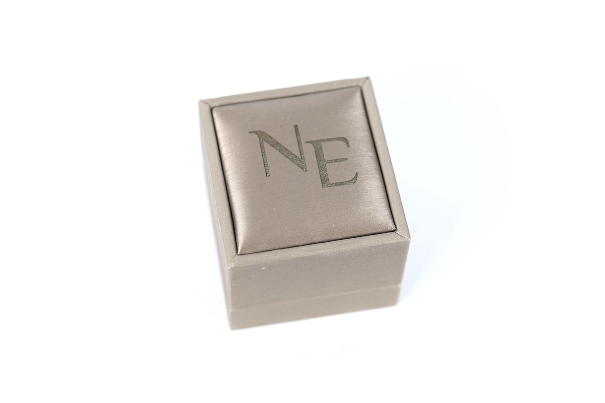 A small, square-shaped box with the letters "NE" printed on it.