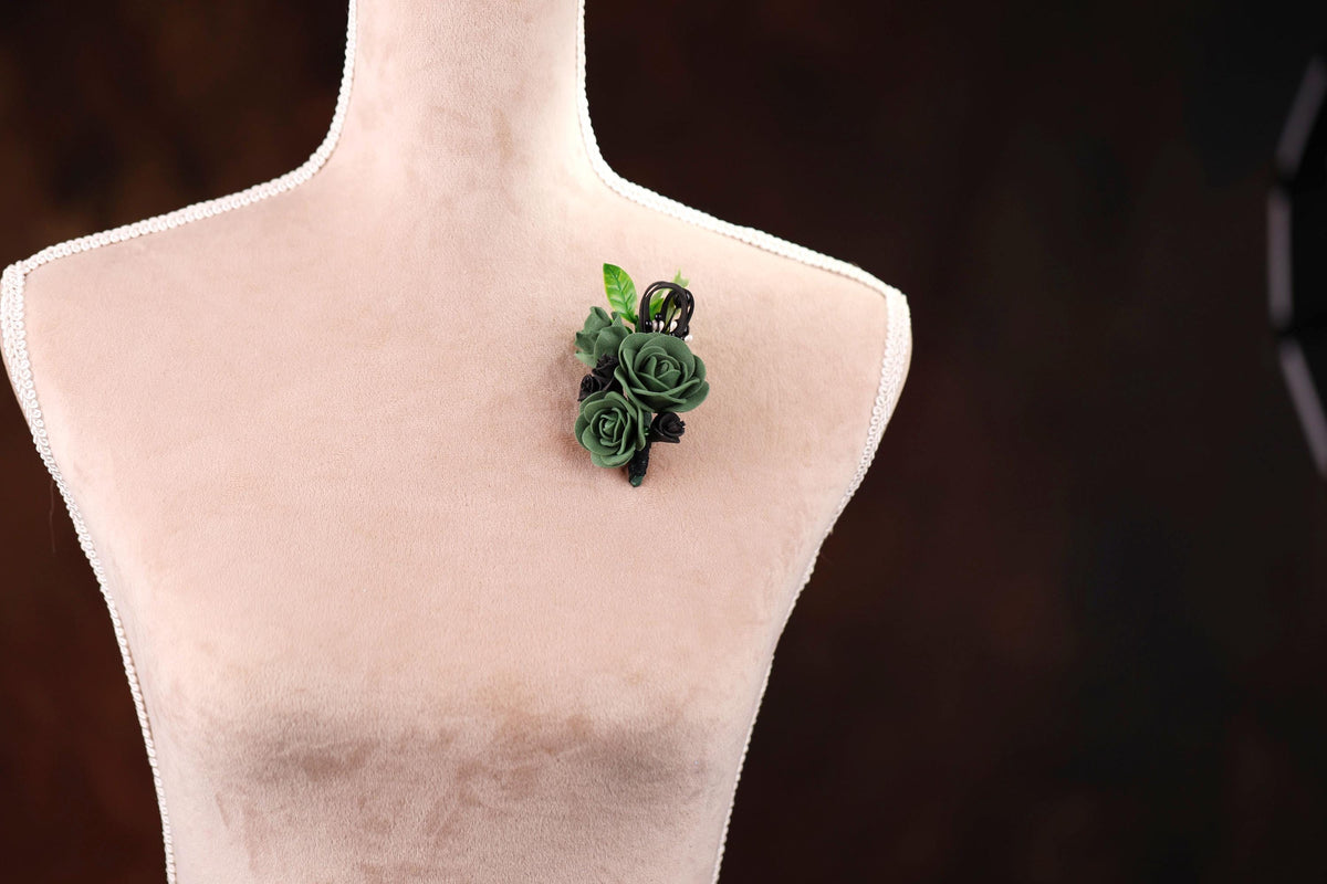a white mannequin with a green flower on it