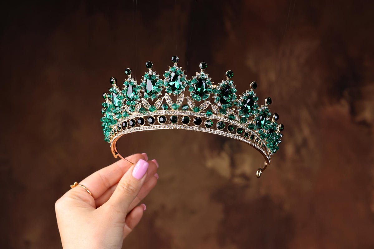 a woman holding a tiara in her hand