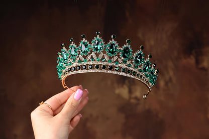 a woman holding a tiara in her hand