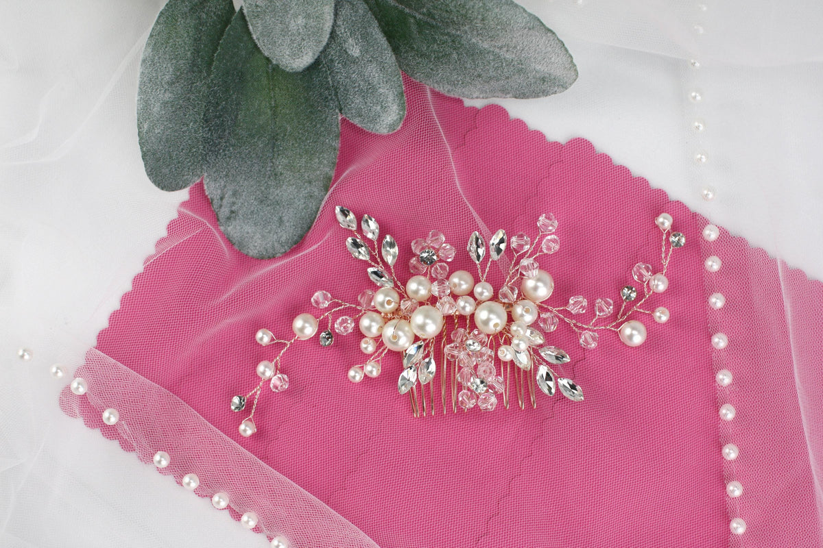 a close up of a brooch on a pink cloth