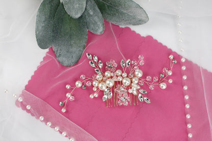 a close up of a brooch on a pink cloth