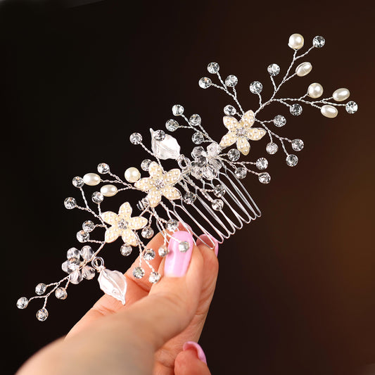 a woman is holding a hair comb with pearls on it