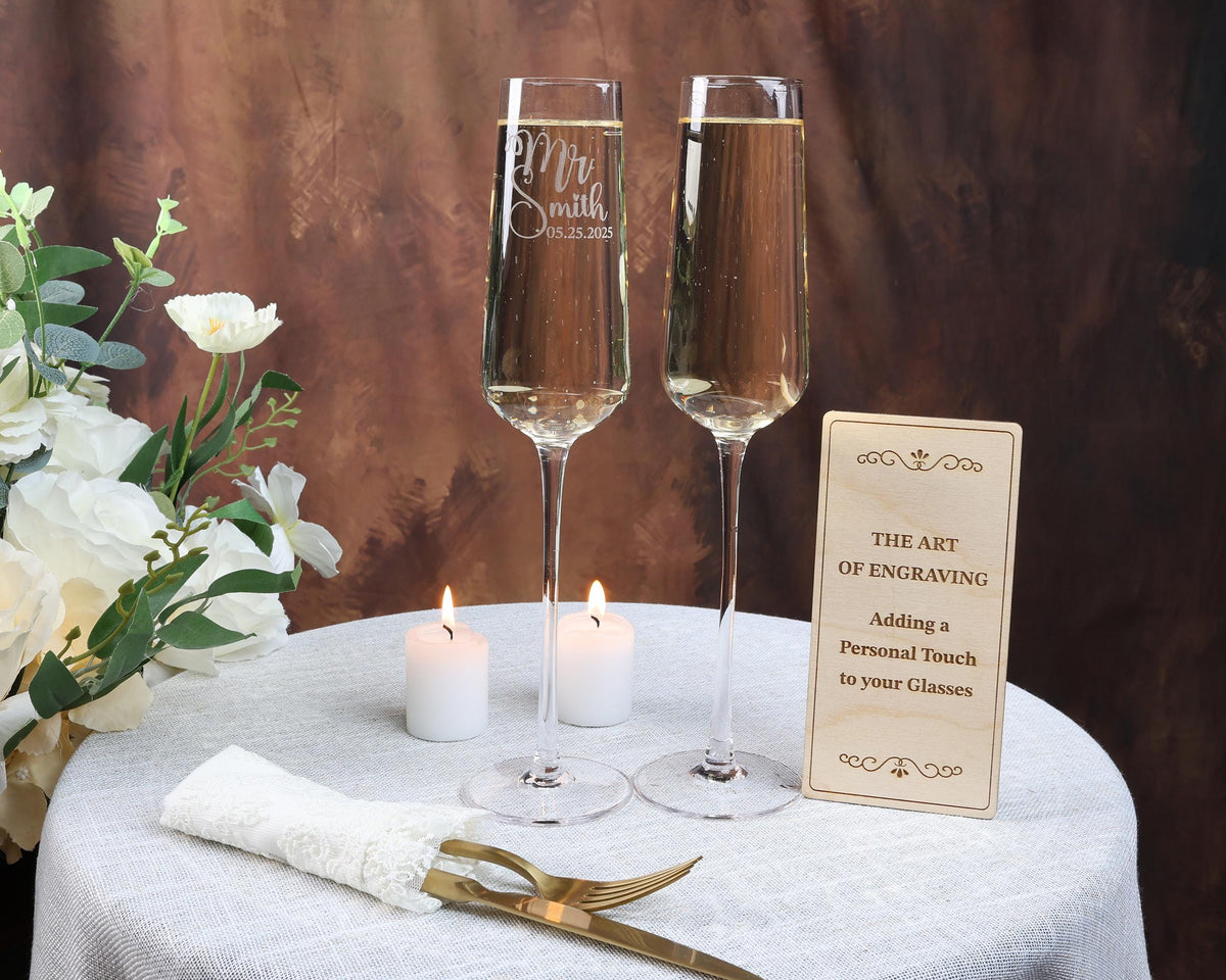 a table with two wine glasses and a sign on it