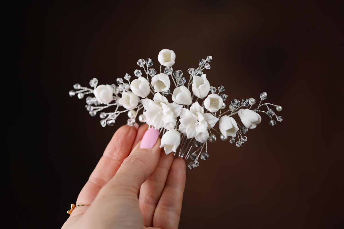 a woman holding a white flower bouquet in her hand