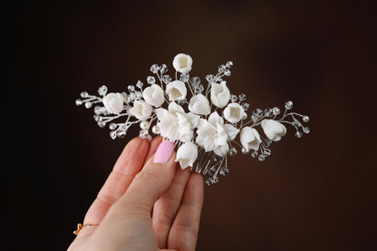 a woman holding a white flower bouquet in her hand