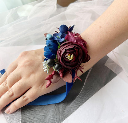 a close up of a person's hand wearing a flower bracelet