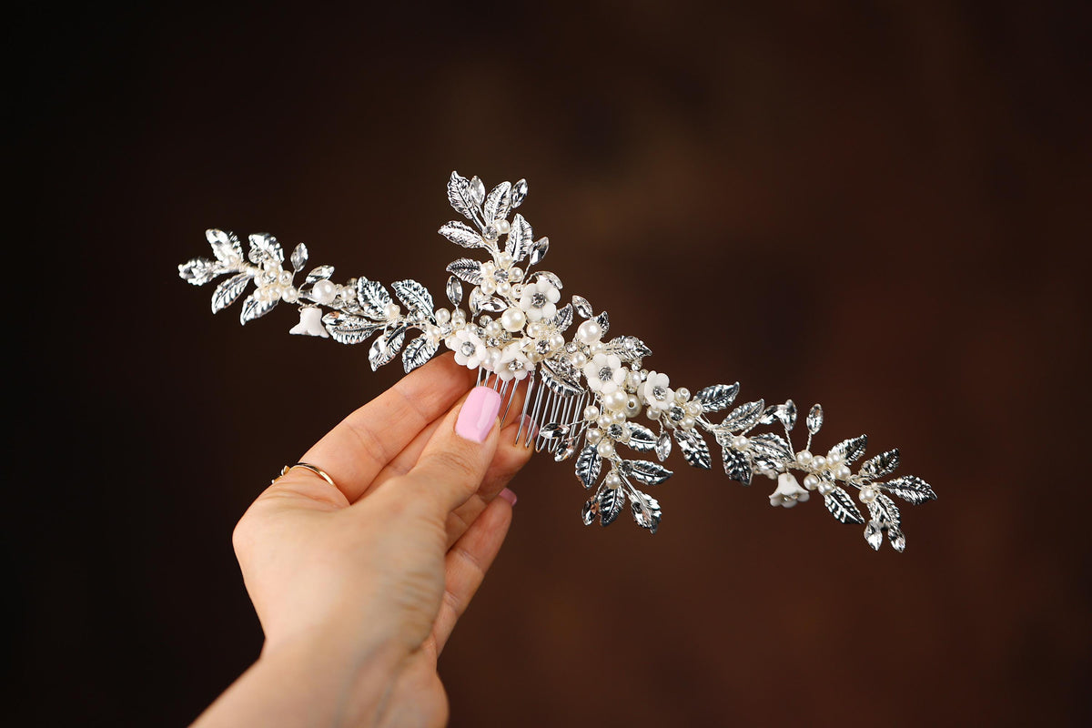 a woman is holding a hair comb in her hand