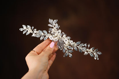 a woman is holding a hair comb in her hand