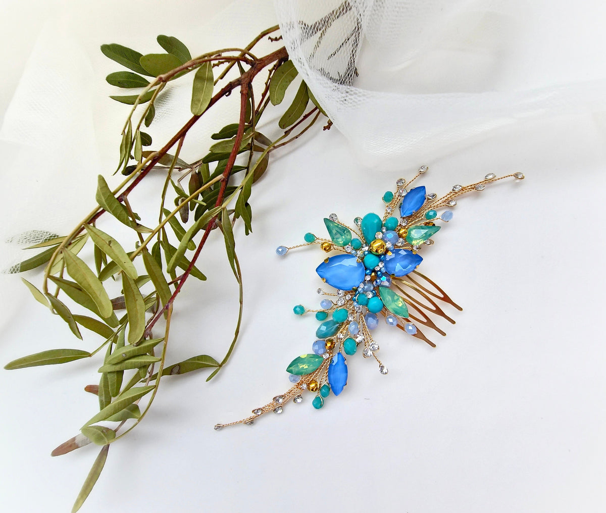 a close up of a flower brooch on a white surface