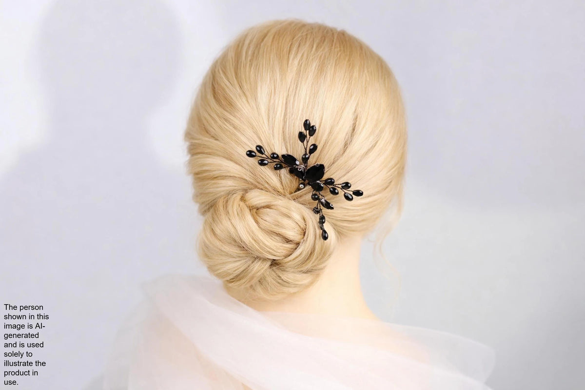 A woman with blonde hair styled in a bun, wearing a black hair accessory with black leaves.