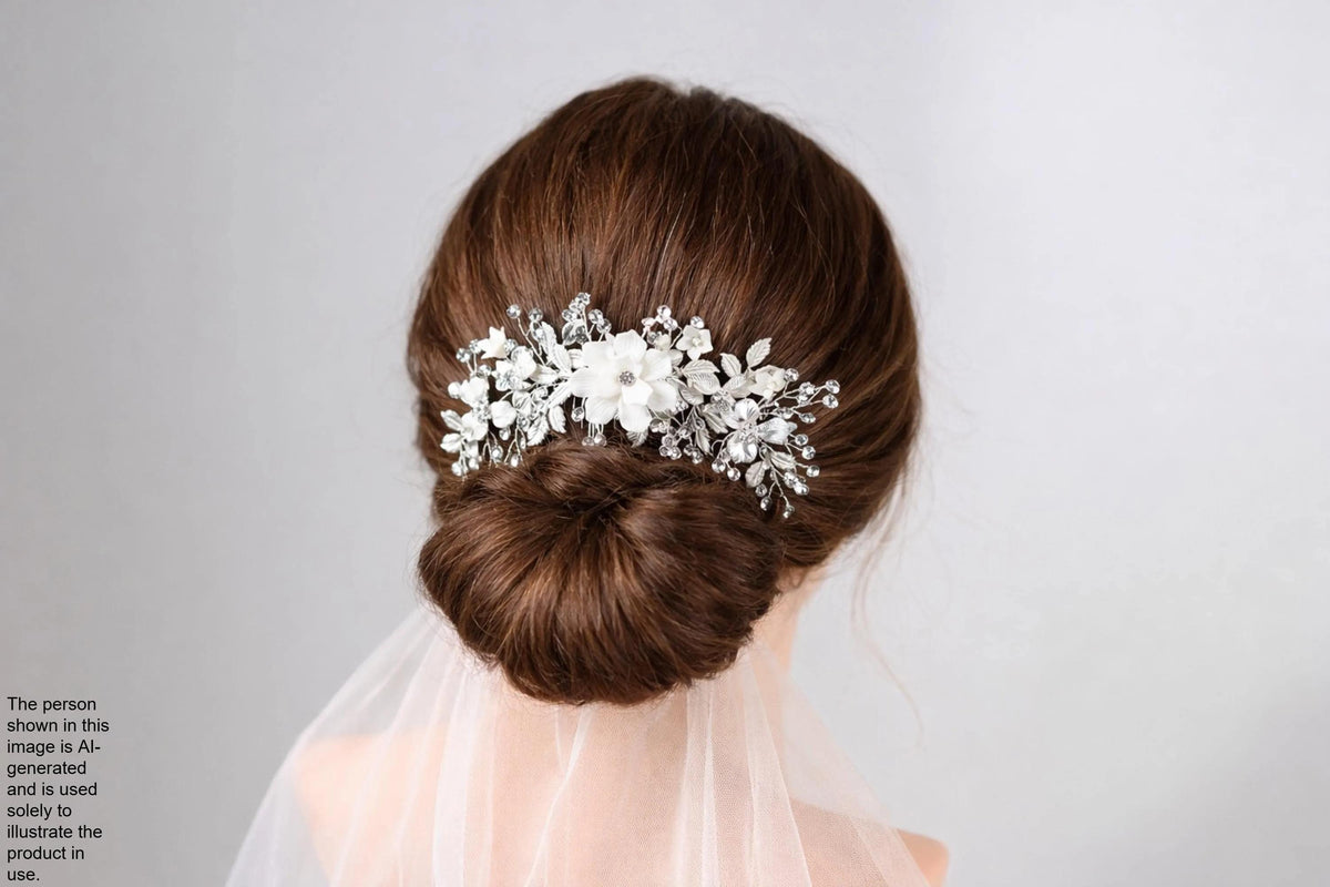 A woman's hair is styled in a bun with a decorative hair accessory featuring white flowers and crystals.